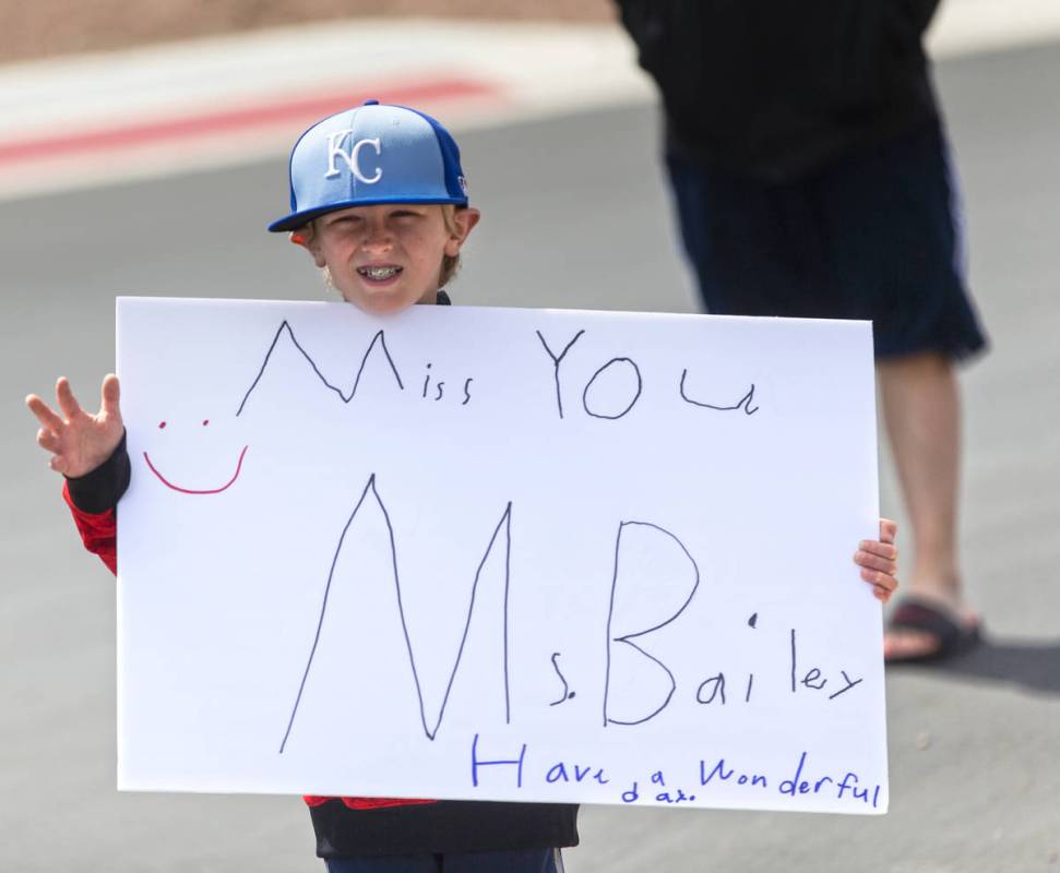 Las Vegas residents wave to teachers and staff from O’Roarke Elementary School who organ ...