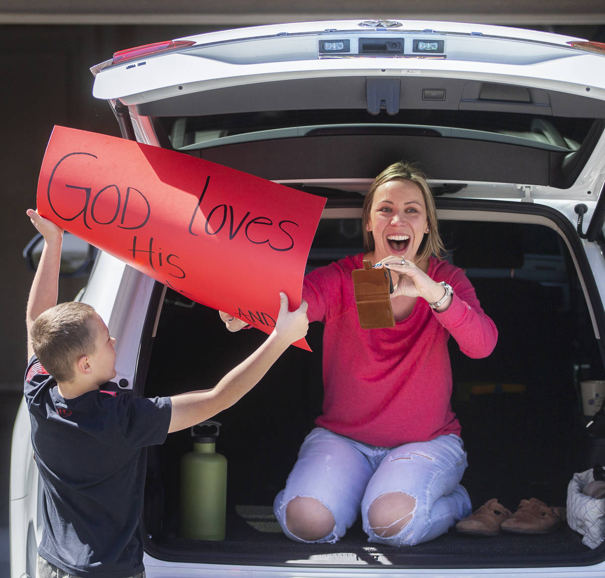 Las Vegas residents wave to teachers and staff from O’Roarke Elementary School who organ ...