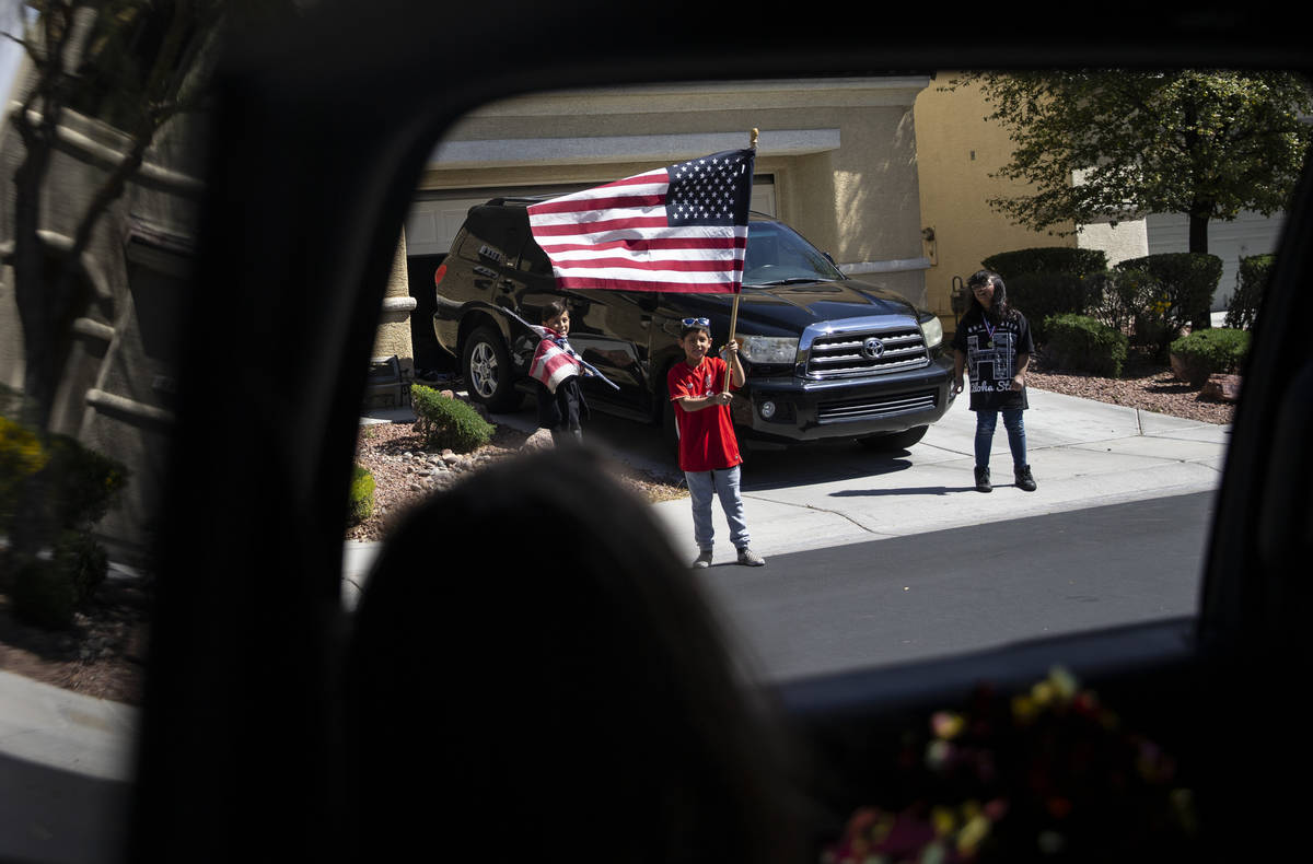 Las Vegas residents wave to teachers and staff from O’Roarke Elementary School who organ ...