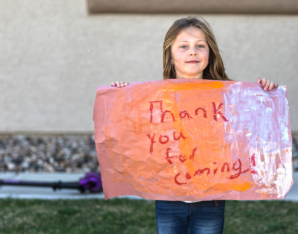 Las Vegas residents wave to teachers and staff from O’Roarke Elementary School who organ ...