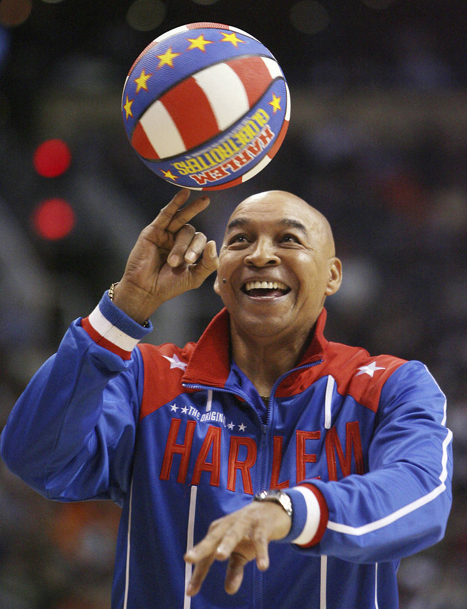 The Harlem Globetrotters' Fred "Curly" Neal performs during a timeout in the second q ...