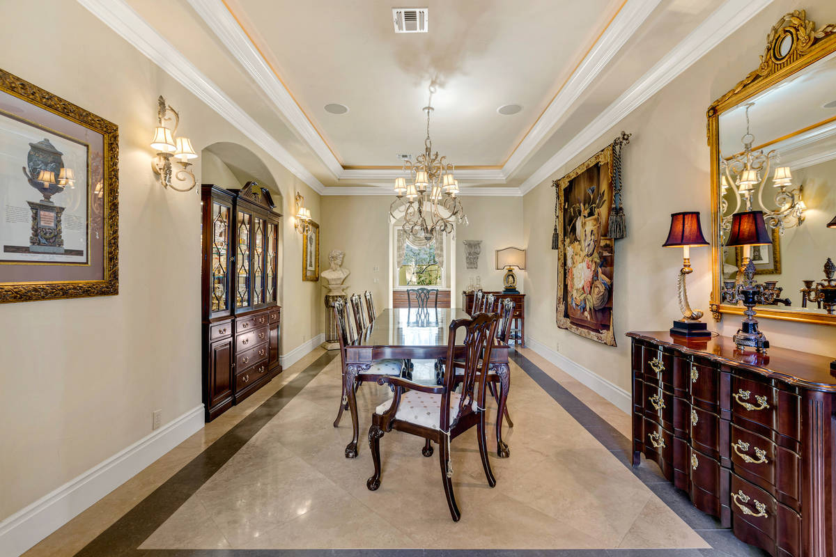 The formal dining room has a French design. (Red Luxury Real Estate)