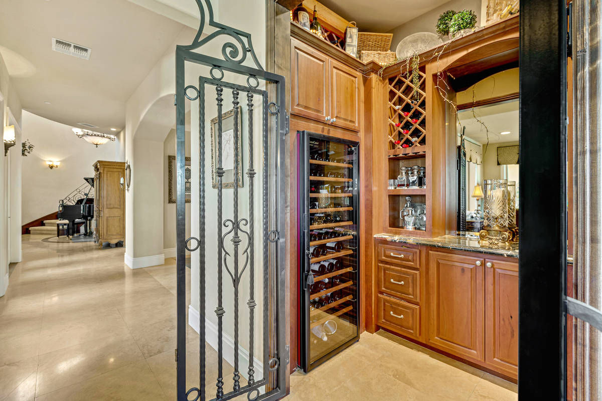 The temperature-controlled wine cellar has wrought iron doors. (Red Luxury Real Estate)