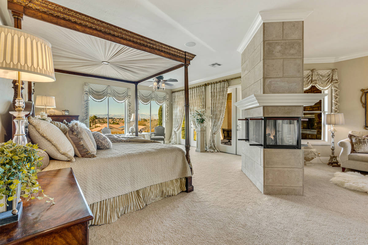 The master suite features a two-sided fireplace and a large sitting area. (Red Luxury Real Estate)