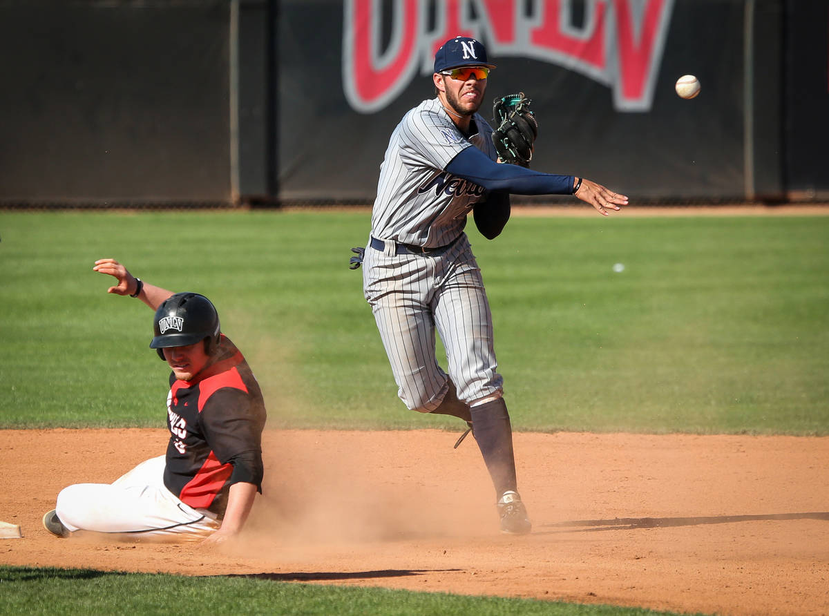UNR infielder Wyatt Tilley (7) throws the ball to first base after getting out UNLV first basem ...