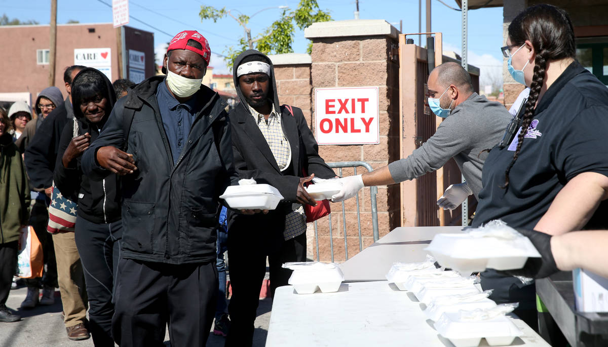 Jeffery Hester, 53, grabs a to-go lunches at Catholic Charities on Foremaster Lane in Las Vegas ...