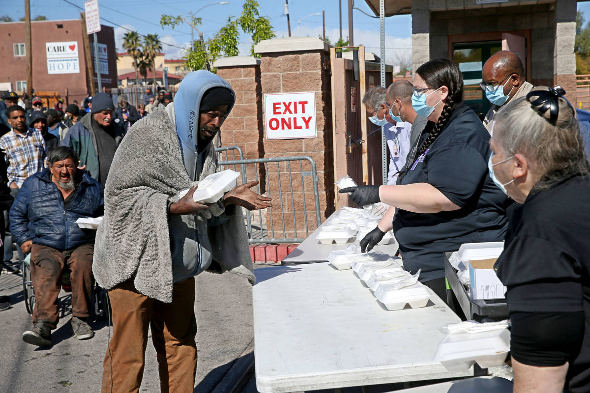 Michael Brown grabs a to-go lunches at Catholic Charities on Foremaster Lane in Las Vegas Thurs ...