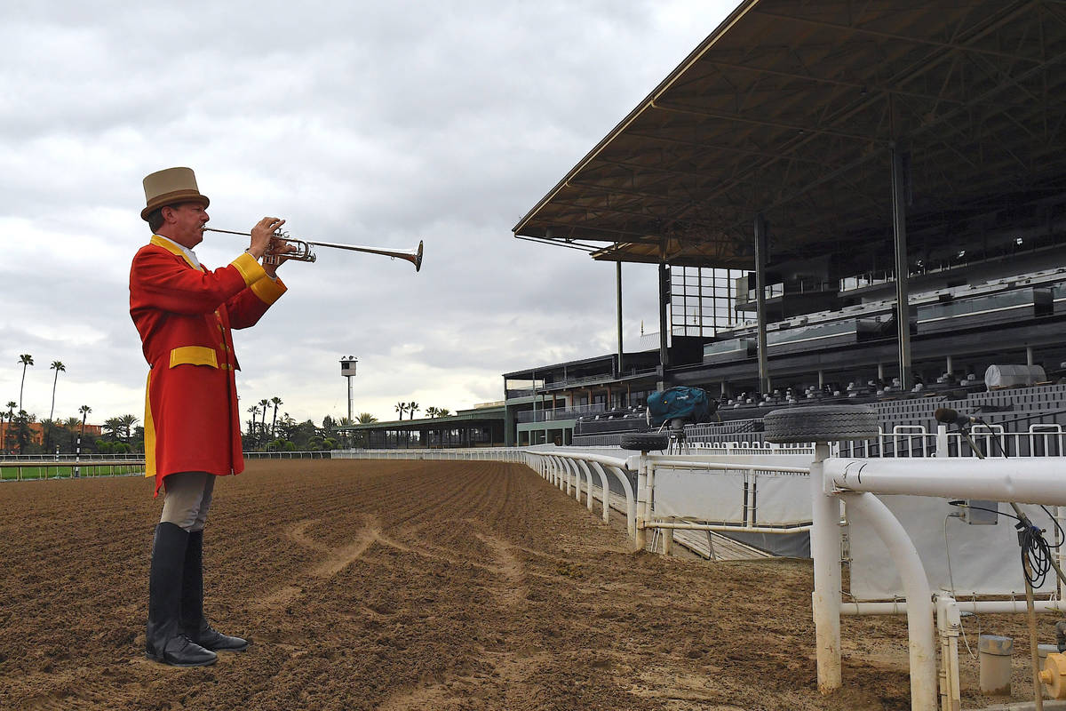 Bugler Jay Cohen plays "First Call" as he calls the riders to post for the first race ...