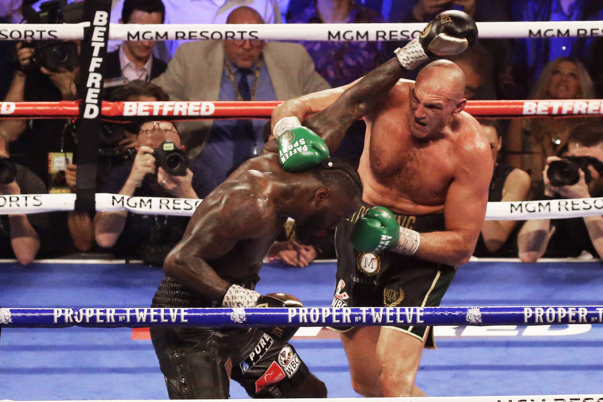 Tyson Fury, right, connects with a right hook against Deontay Wilder in the fifth round during ...