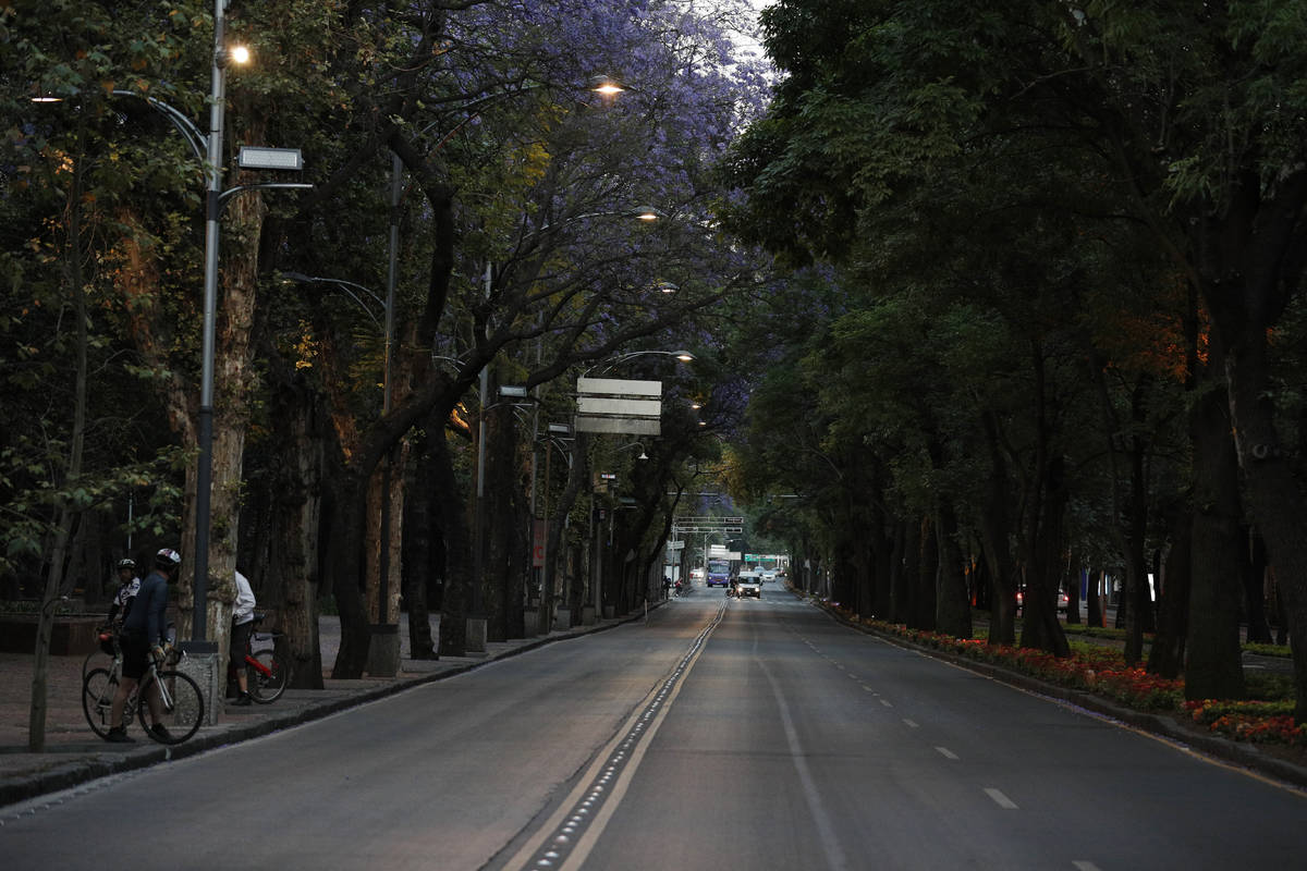 Little traffic is seen on the usually crowded Paseo de la Reforma in Mexico City, at dusk Satur ...