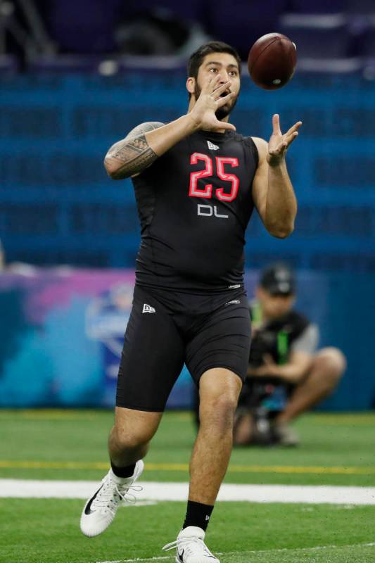 Iowa defensive lineman A J Epenesa runs a drill at the NFL football scouting combine in Indiana ...