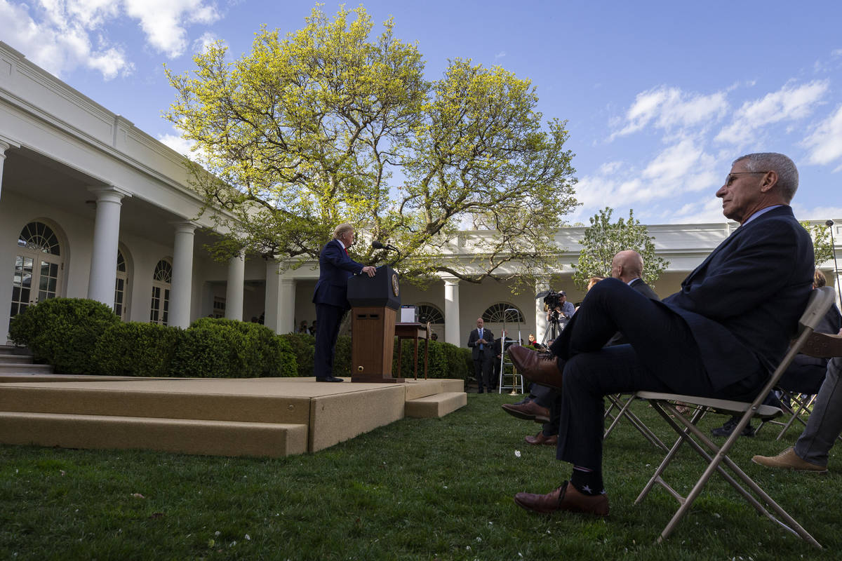 President Donald Trump speaks as Dr. Anthony Fauci, director of the National Institute of Aller ...