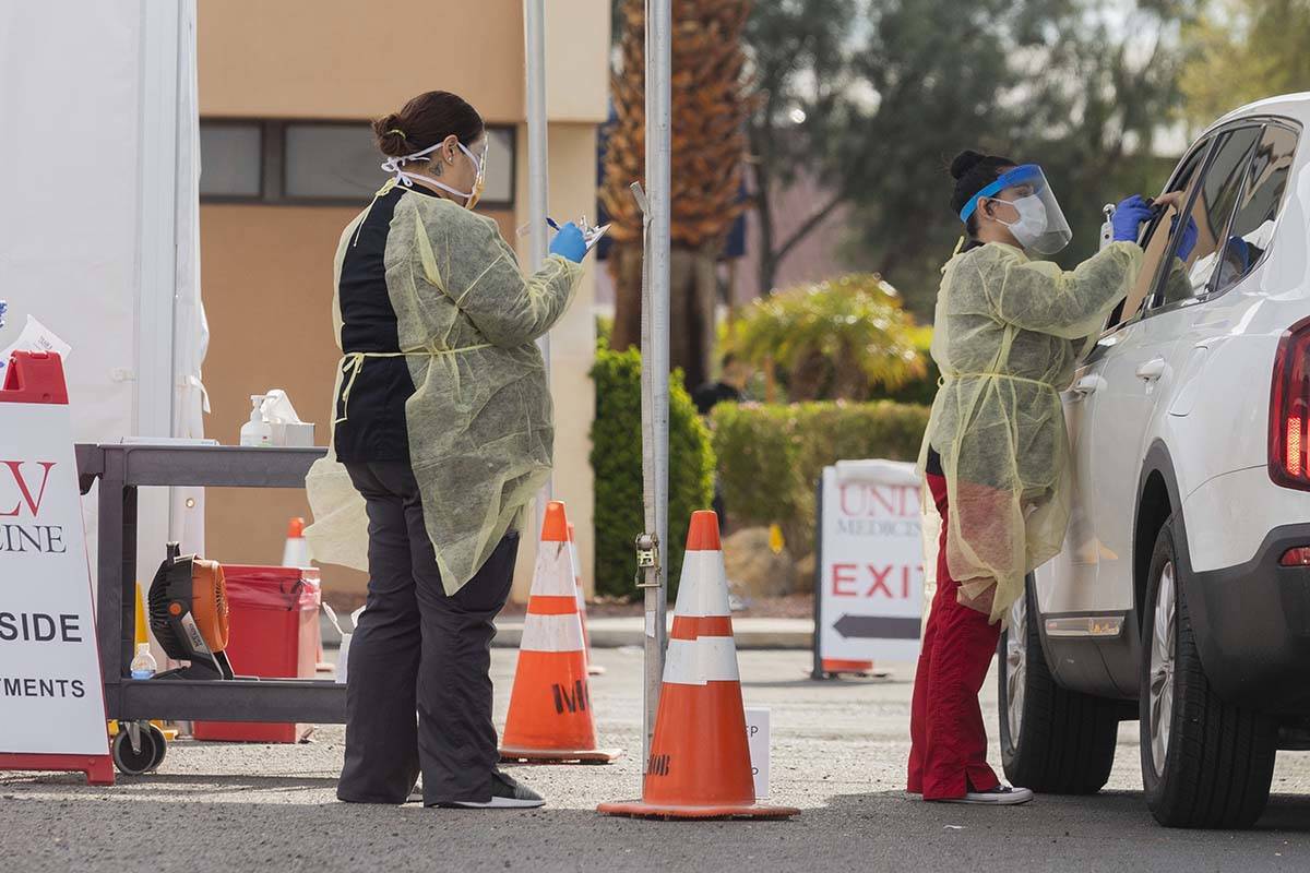 UNLV Medicine medical professionals conduct a curbside test on a patient experiencing coronavir ...