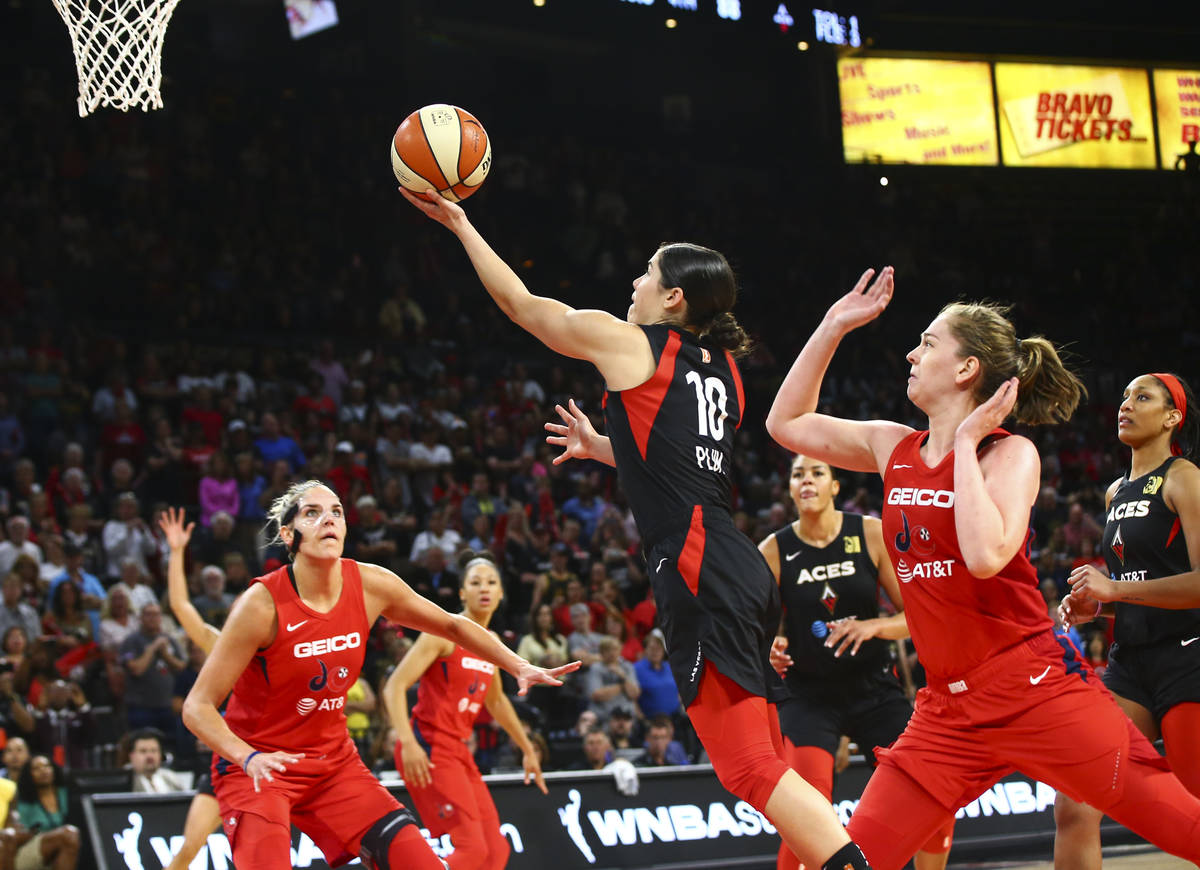 Las Vegas Aces' Kelsey Plum (10) goes to the basket past Washington Mystics' Emma Meesseman dur ...