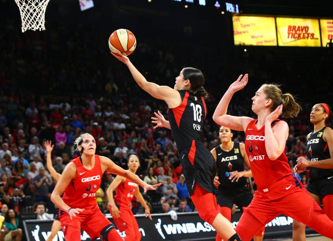 Las Vegas Aces' Kelsey Plum (10) goes to the basket past Washington Mystics' Emma Meesseman dur ...