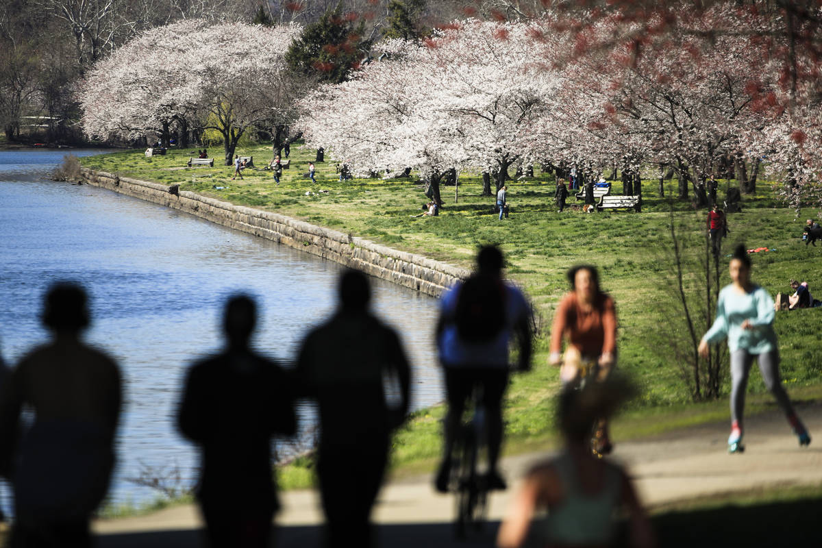 In a March 26, 2020, file photo, people exercise on the trail along Kelly Drive in Philadelphia ...