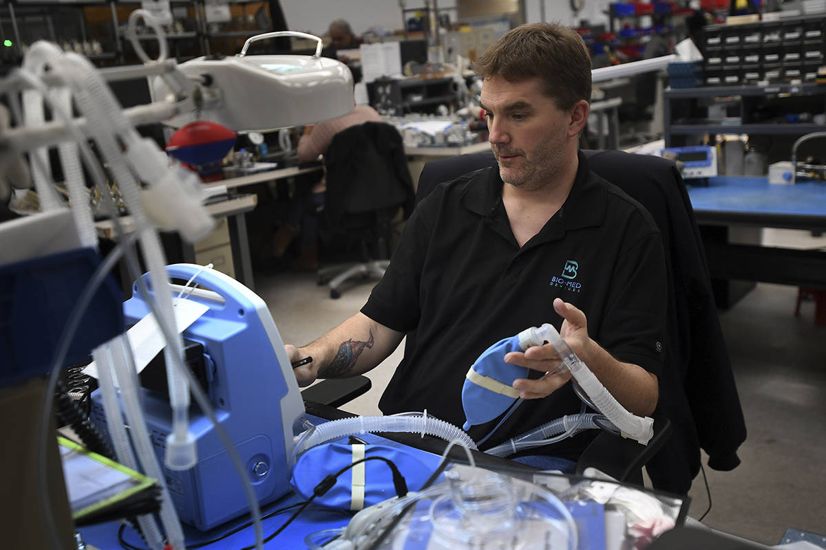Service Manager Keith Wilson tests a TV100 ventilator at medical equipment manufacturer Bio-Med ...