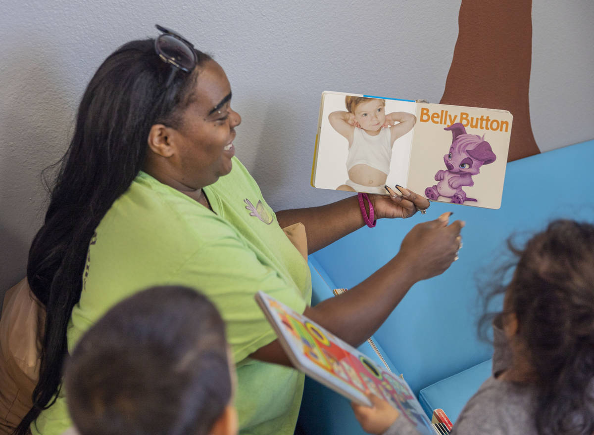 Discovery Gardens Childcare teacher Demetria Robinson reads a book to her toddler class at the ...