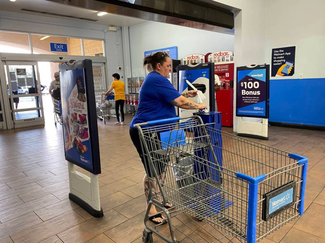 A customers grabs sanitizing wipes at Walmart Supercenter at 3950 W. Lake Mead Blvd. in North L ...