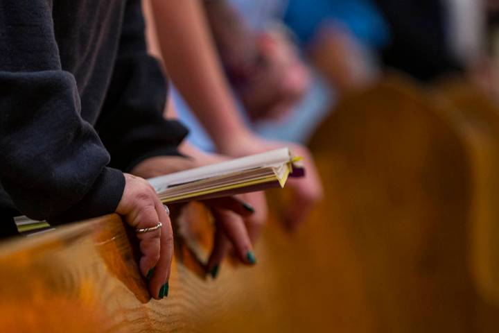 Parishioners pray during Sunday Mass at St. Anne's Catholic Church where they were asked to use ...