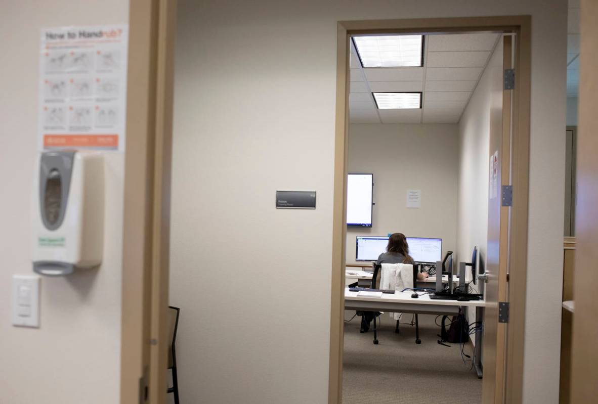 Danyelle Myers, a third-year OBGYN resident, answers calls at a COVID-19 call center at a UNLV ...