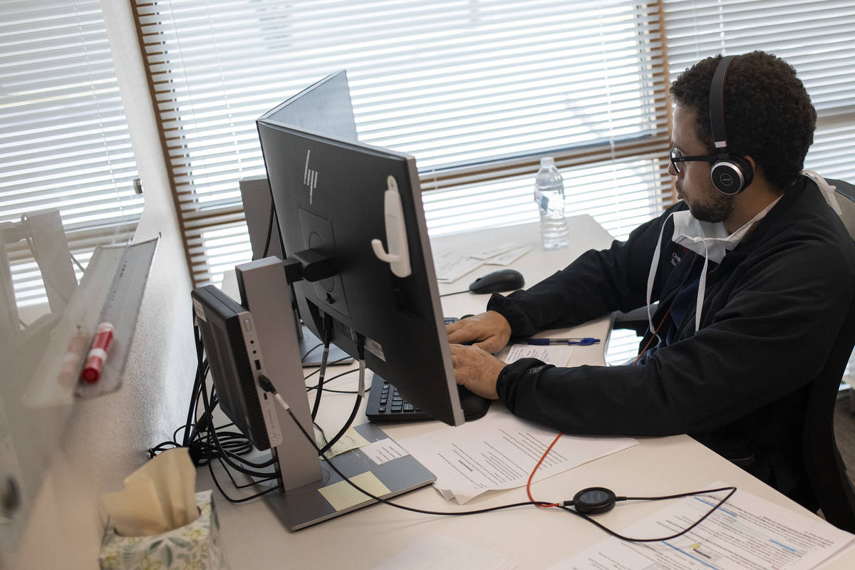 Dr. Toure Vashon, a third-year resident, fields calls from potential coronavirus patients at a ...