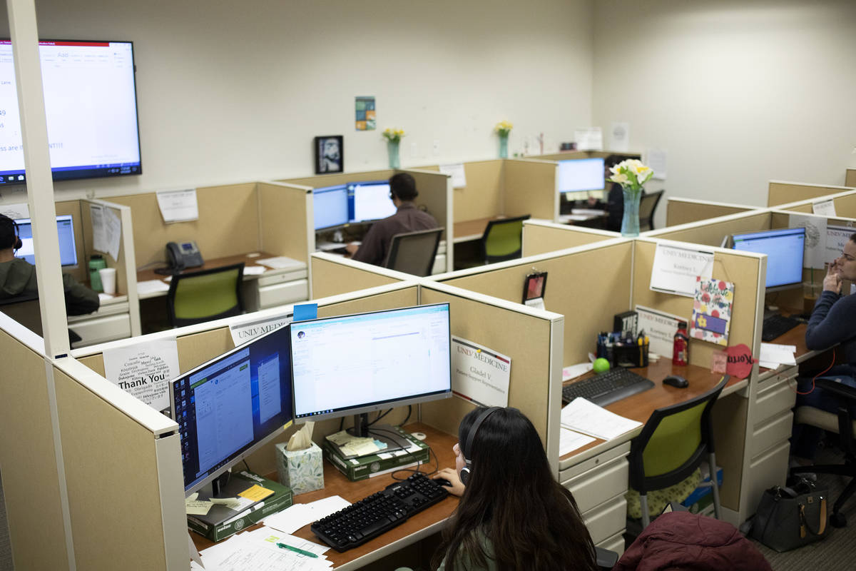 UNLV medical students and residents volunteer to answer calls from community members to determi ...