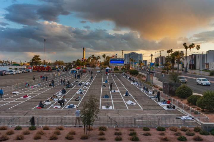 Homeless people settle in for the night with social distancing at the temporary shelter in the ...