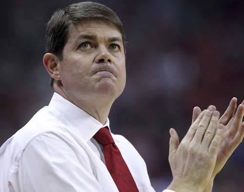 UNLV head coach Dave Rice claps after instructing his team during the first half of an NCAA bas ...