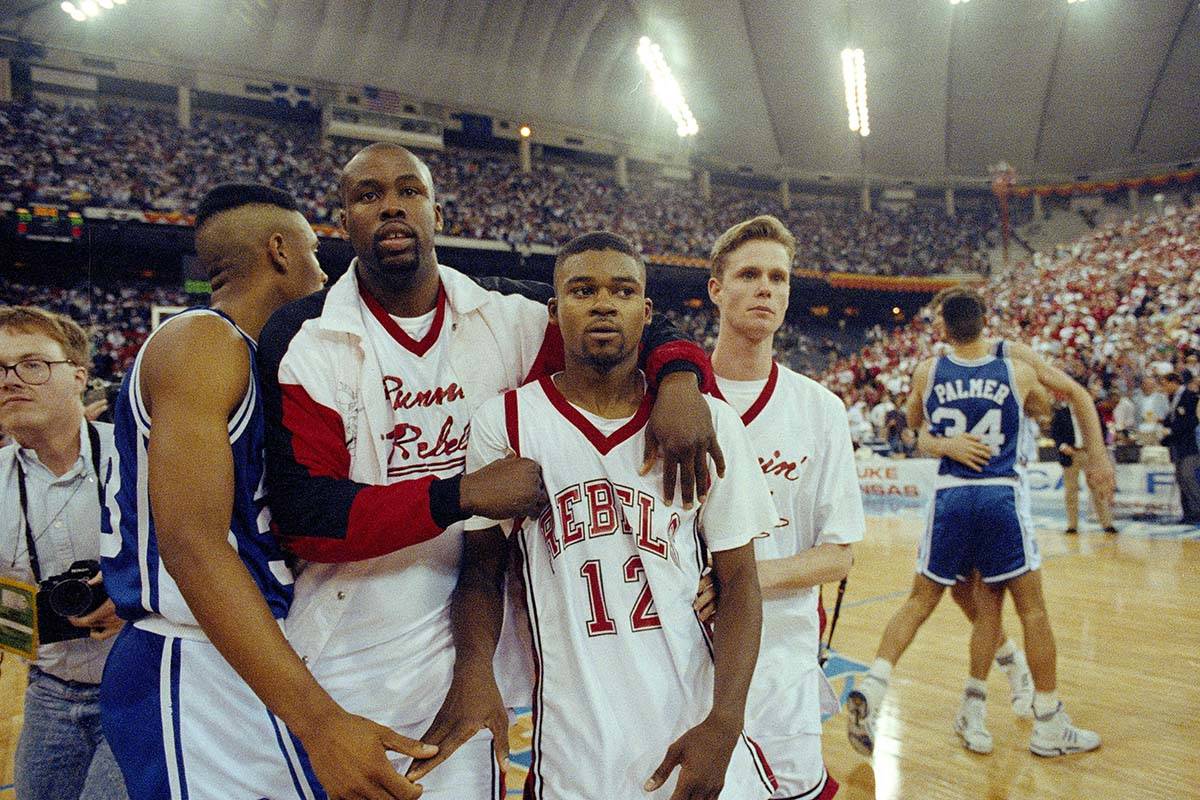 In this March 30, 1991, file photo, UNLV's Anderson Hunt (12) and unidentified teammates leave ...