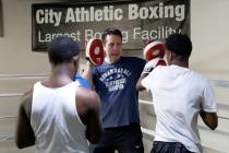 Armin Van Damme, owner of City Athletic Boxing, center, works with youth from the Spring Mounta ...