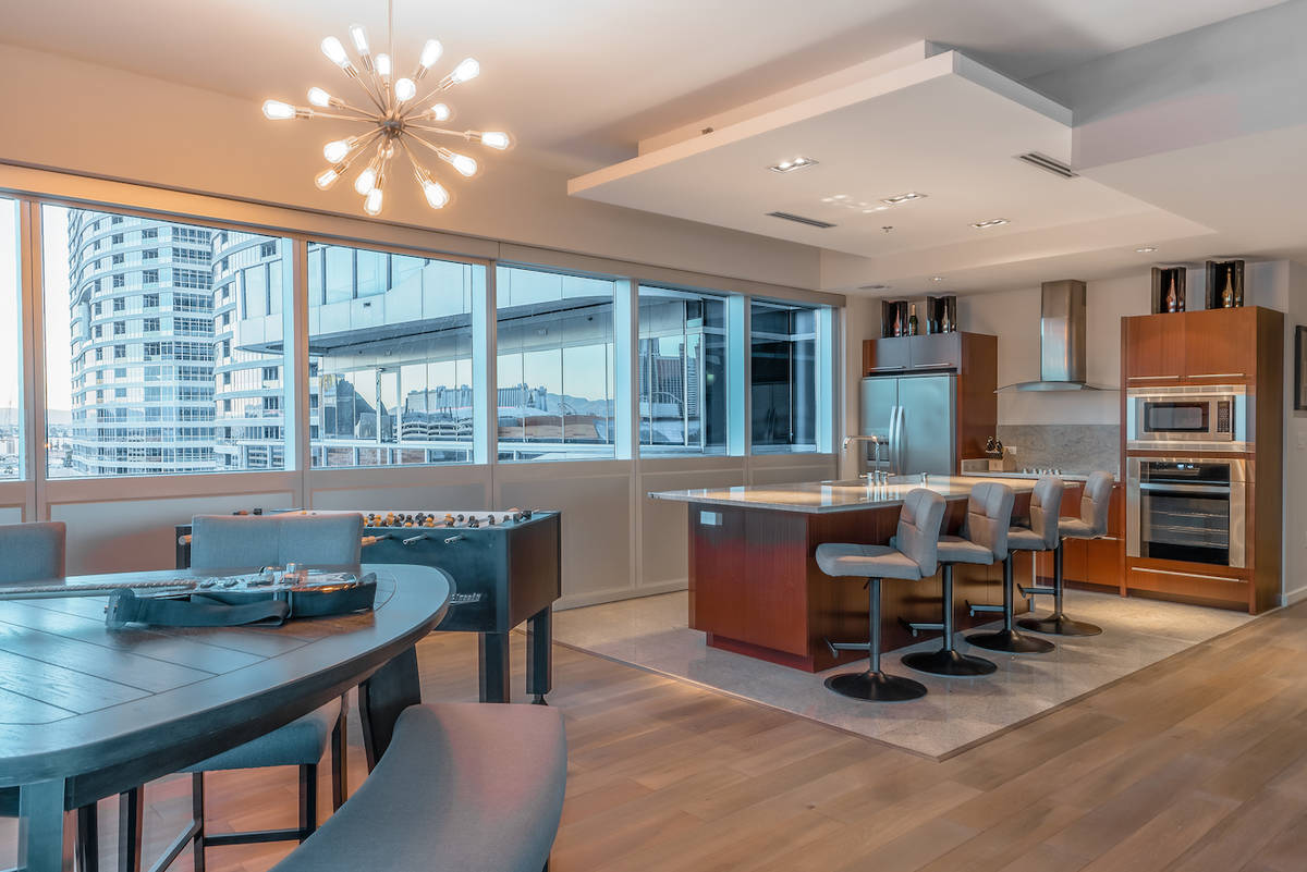 The kitchen and dining room face a floor-to-ceiling wall of glass with views of the Strip. (Red ...