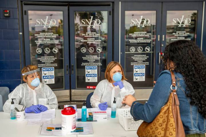 Southern Nevada Health District Registered nurse Joanna Corpuz, left, and immunization clinic a ...