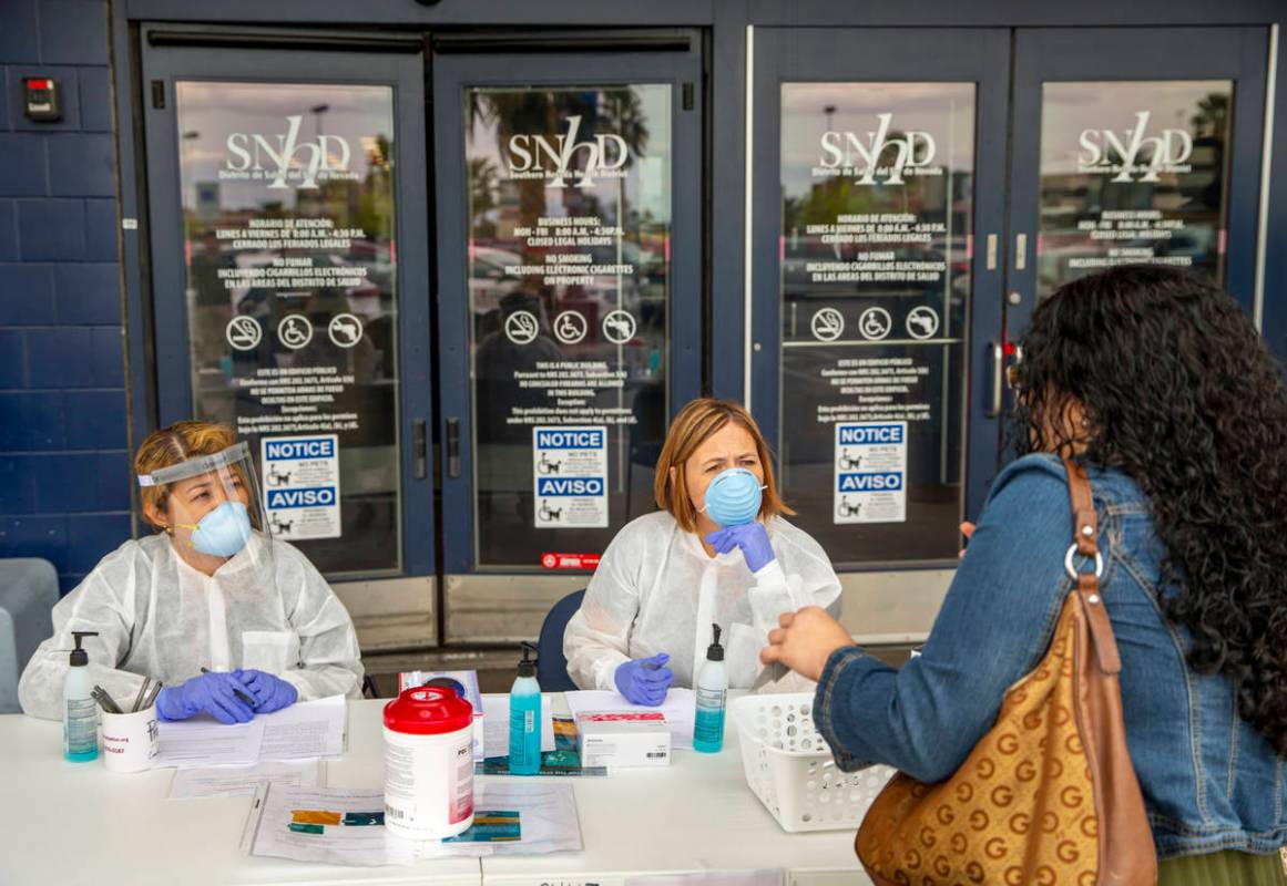 Southern Nevada Health District Registered nurse Joanna Corpuz, left, and immunization clinic a ...