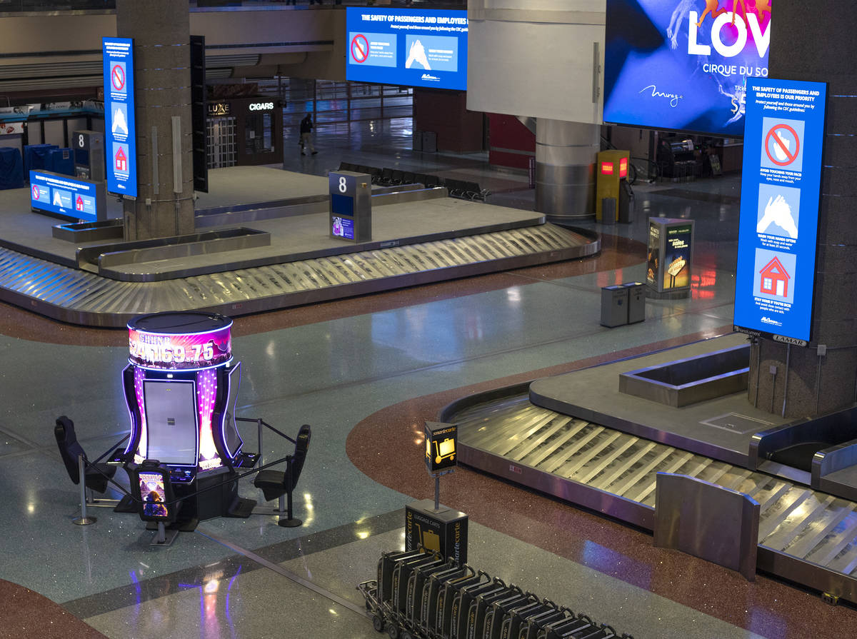 Baggage carousels sit unused at McCarran International Airport on Wednesday, April 1, 2020, in ...