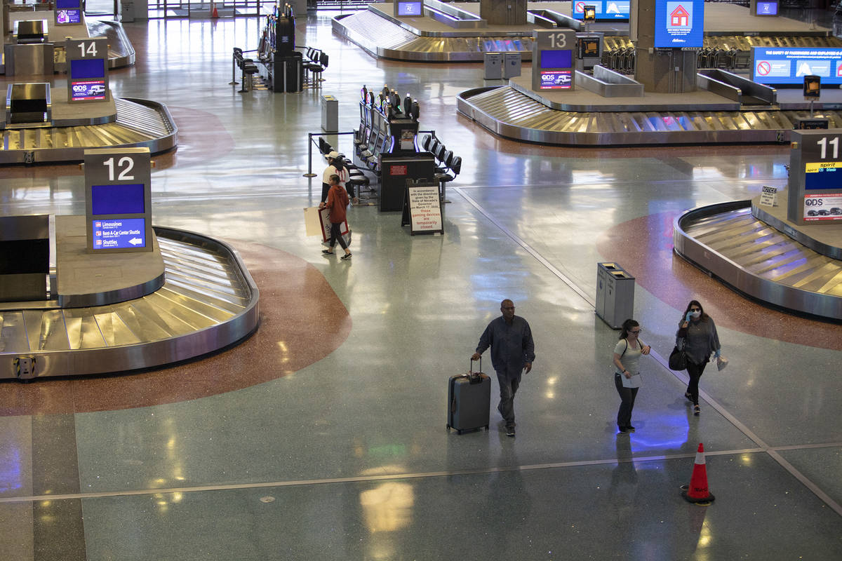 Travelers move through baggage claim at McCarran International Airport on Wednesday, April 1, 2 ...
