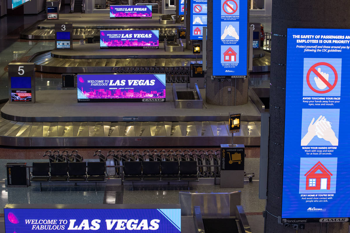 Baggage carousels sit unused at McCarran International Airport on Wednesday, April 1, 2020, in ...