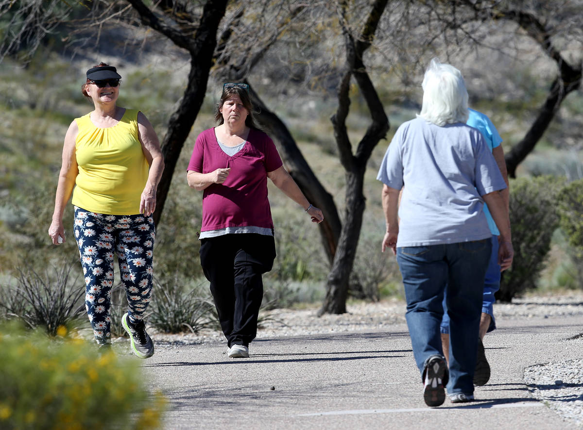 Rebecca Rovere, left, and Andrea Palmer pass Mary Scharn, 84, right and Barbara Cots, 70, while ...