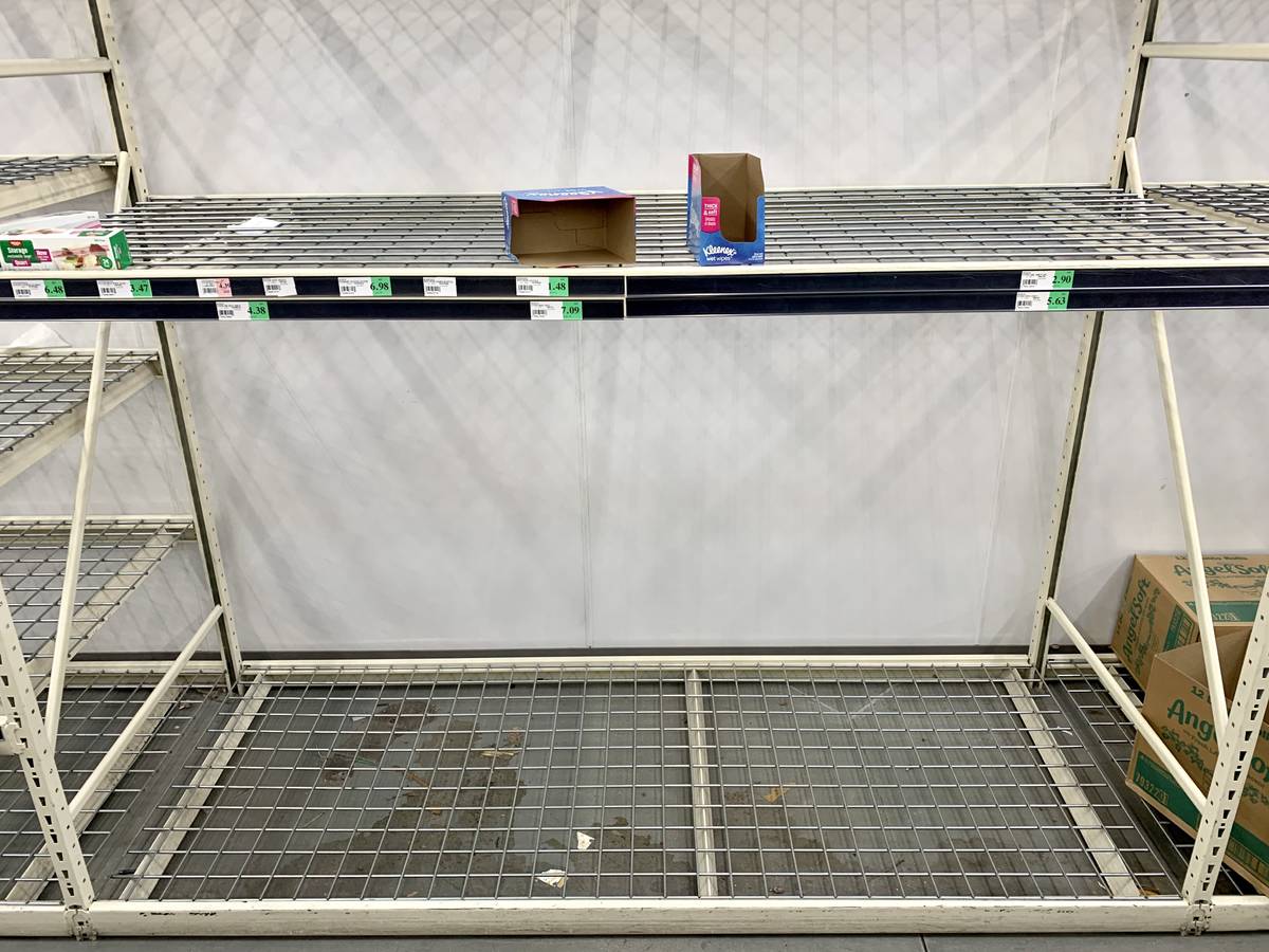 Shelves meant to hold sanitary paper supplies are completely empty at WinCo Foods on N Stephani ...