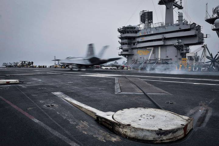 In this Wednesday, April 15, 2015 image released by U.S. Navy Media Content Services, an F/A-18 ...