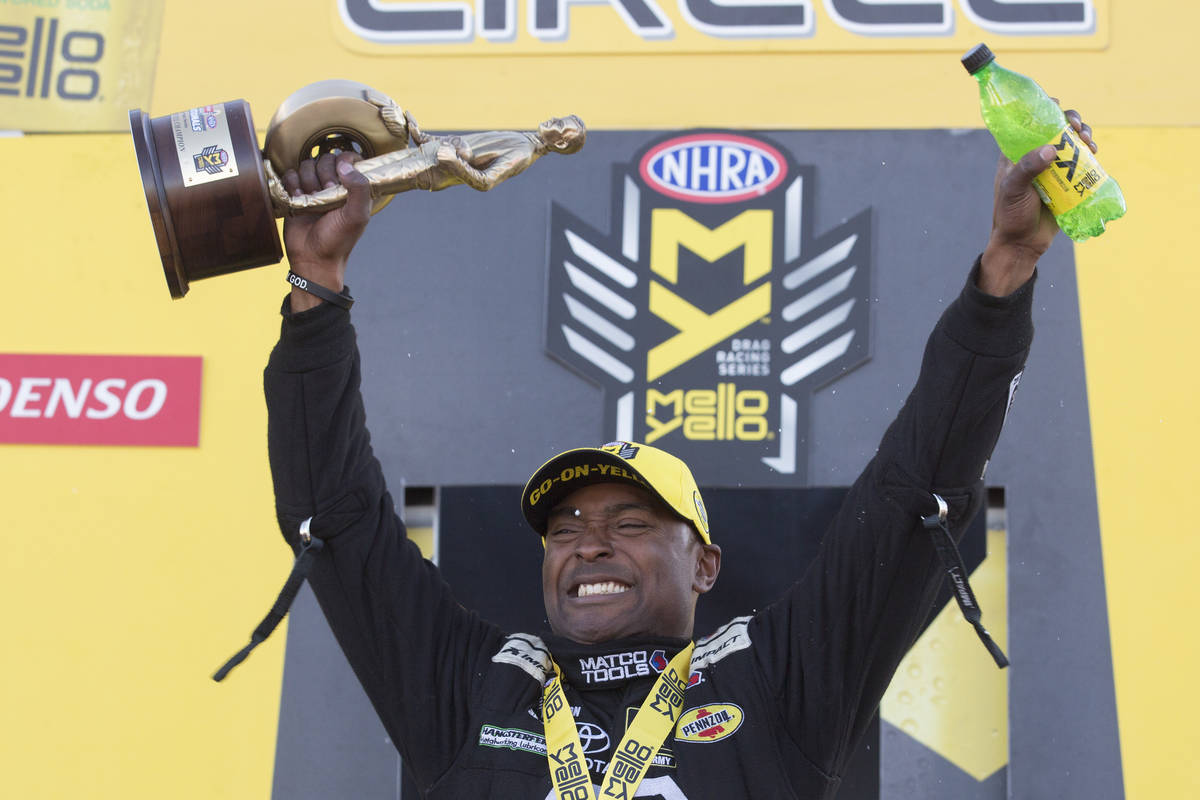 Top Fuel driver Antron Brown holds his trophy at the DENSO Spark Plugs NHRA Nationals at The St ...