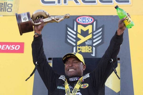 Top Fuel driver Antron Brown holds his trophy at the DENSO Spark Plugs NHRA Nationals at The St ...