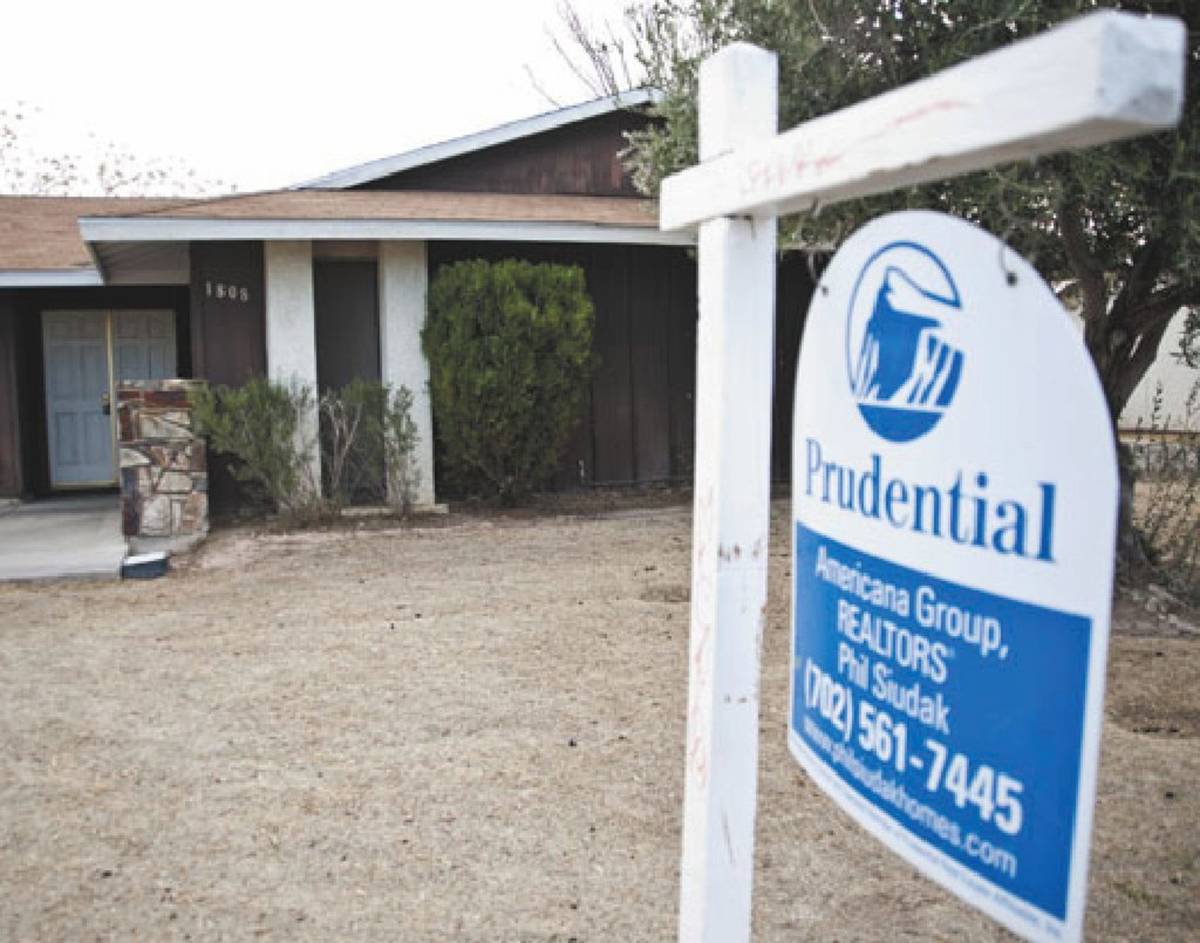 A Realtor sign is shown posted outside a foreclosed upon house in a Las Vegas neighborhood in a ...