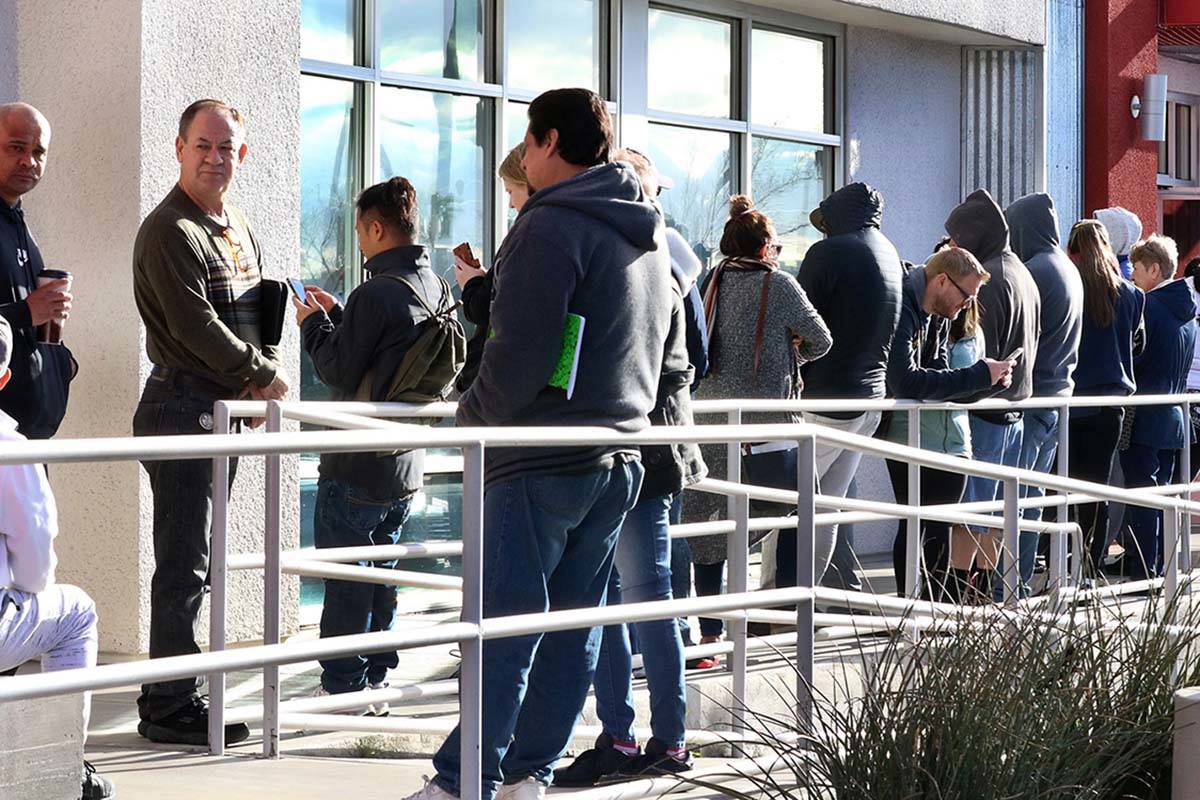People wait in line at One-Stop Career Center on Tuesday, March 17, 2020, in Las Vegas. (Bizuay ...