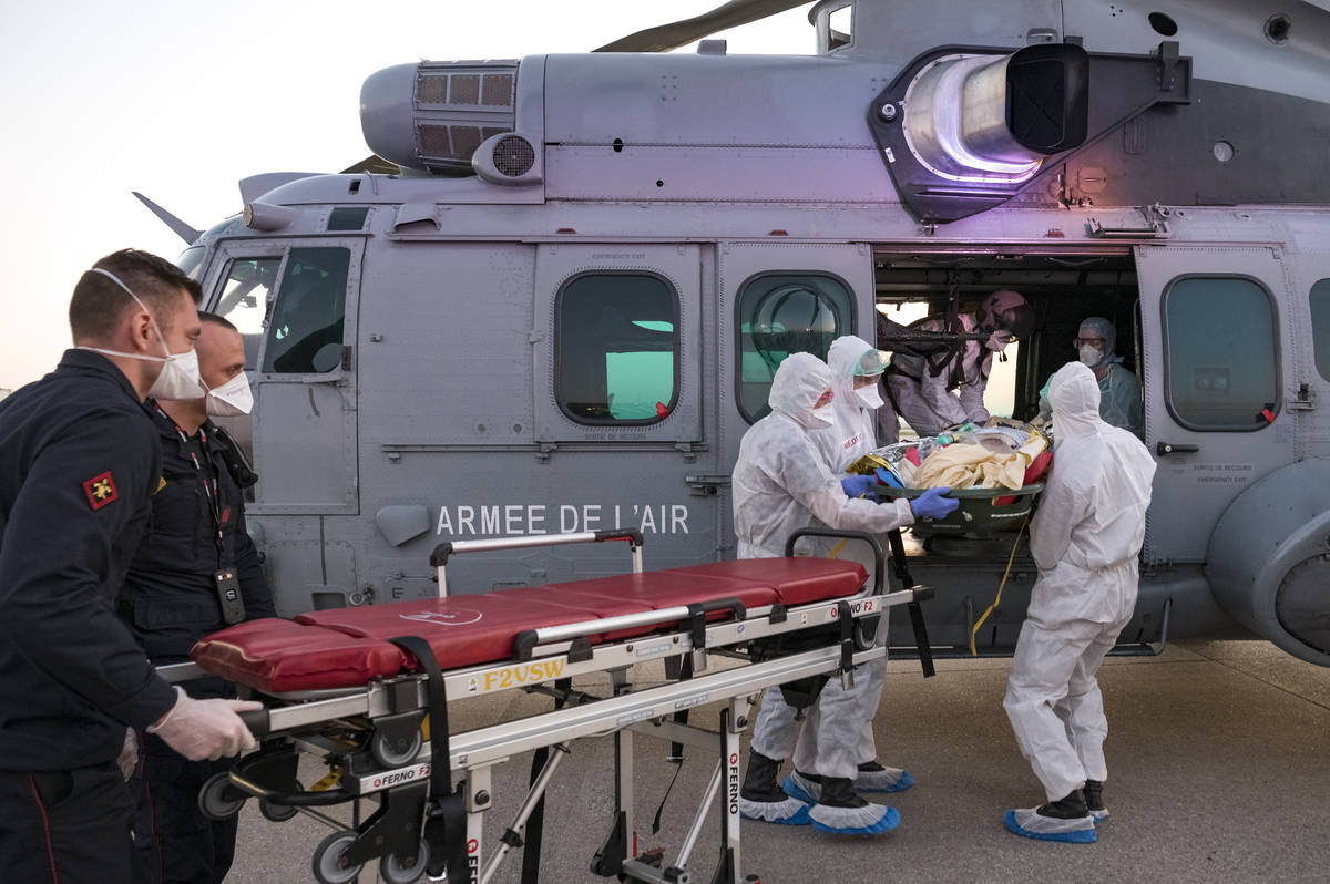 In this photo provided by the French Army Thursday, April 2, 2020, medical staffs evacuate a pa ...