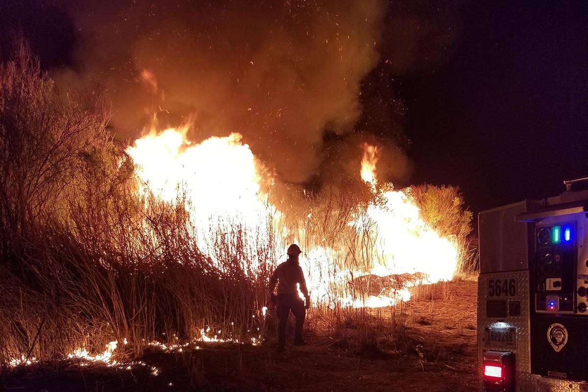 Clark County firefighters respond to a 10-acre fire in the preserve section of Wetlands Park in ...