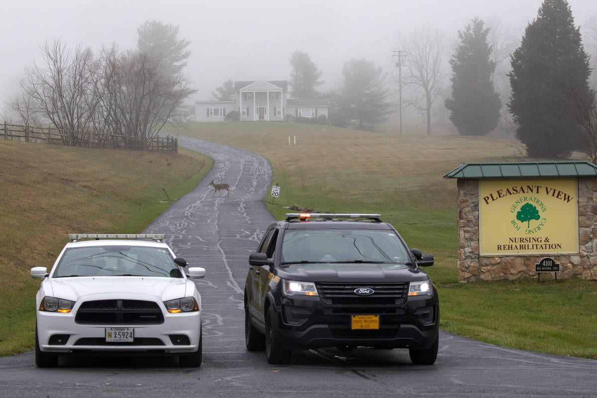 A deer crosses through the fog as a Carroll County Sheriff officer and a Maryland State Trooper ...