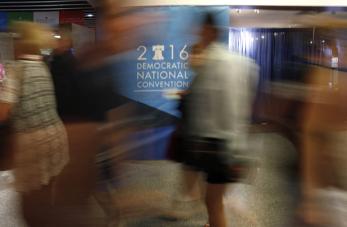 Attendees walk a hall in the Wells Fargo Center before the start of the final day of the Democr ...