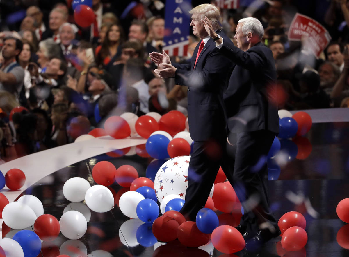 Republican presidential candidate Donald Trump, center left, walks with vice presidential candi ...