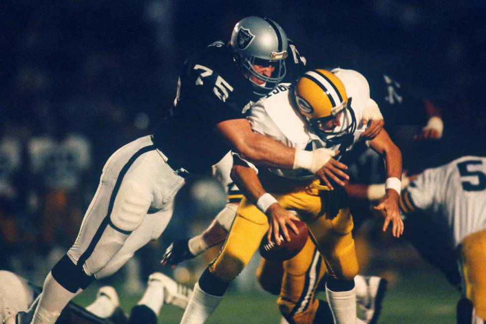 Los Angeles Raiders Hall of Fame defensive end Howie Long (75) sacks Green Bay Packers quarterb ...